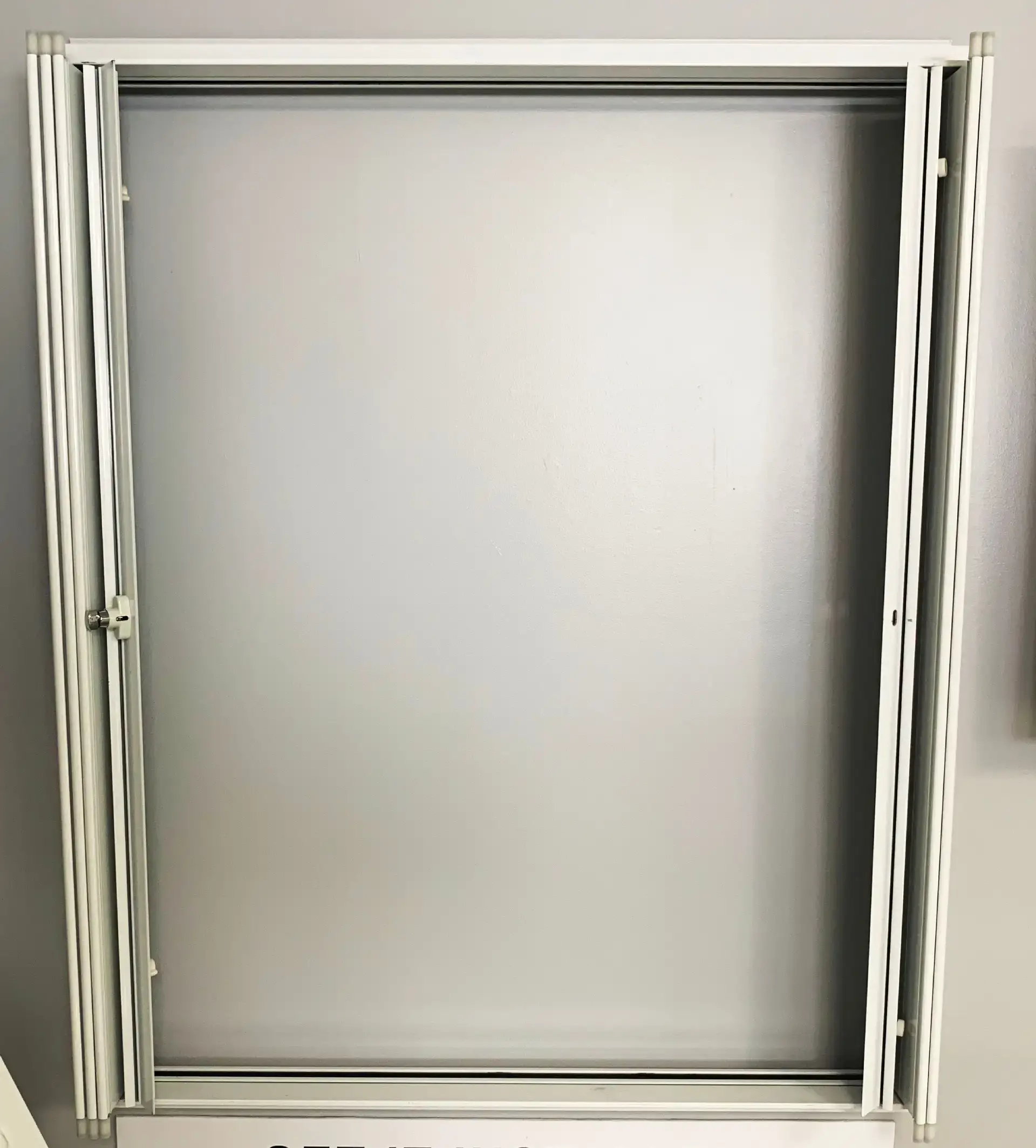 Accordion shutter stacked into its housing beside a window on a South Florida home