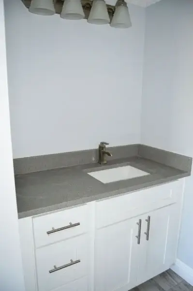 Walk-in shower with glass door and full-height tile in a renovated bathroom