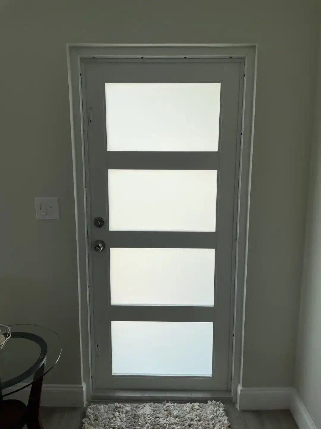 Impact-rated front entry door with decorative glass installed on a South Florida home