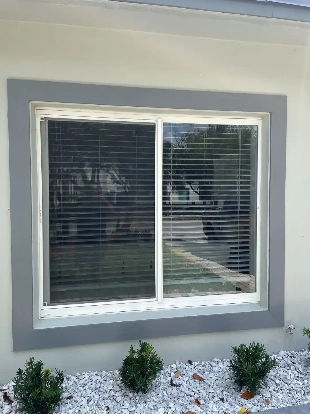Impact-rated sliding patio door opening onto a South Florida yard