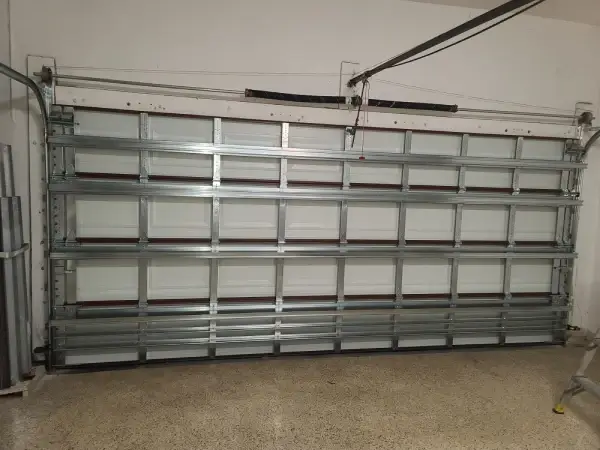 Interior of a new double garage door showing the track and torsion spring
