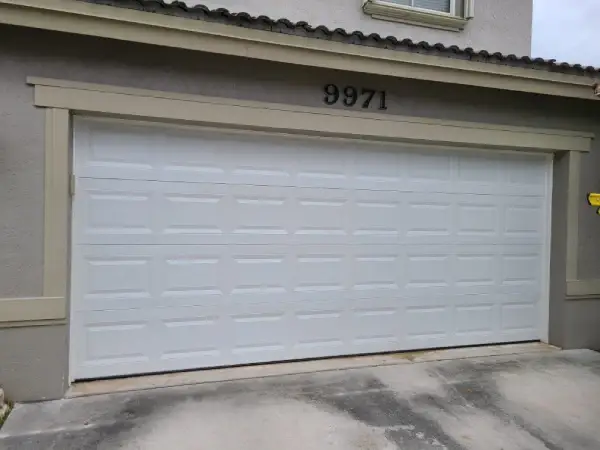 New garage door and opener installed in a residential garage