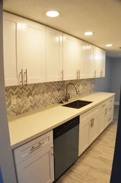 Kitchen remodel with white shaker cabinets and a mosaic tile backsplash