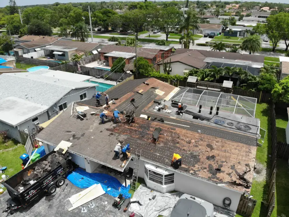 Aerial shot of a low-slope roof section tied into a sloped shingle roof