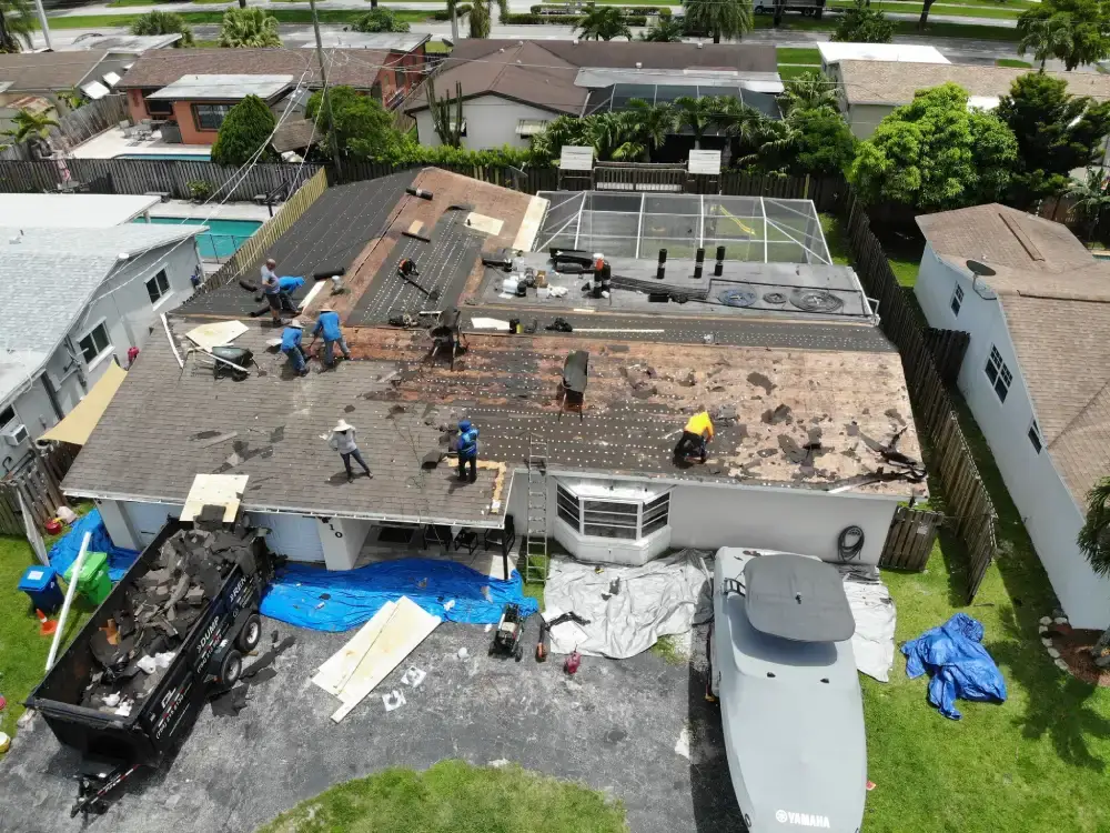 Roof replacement underway on a South Florida home with materials staged on the deck