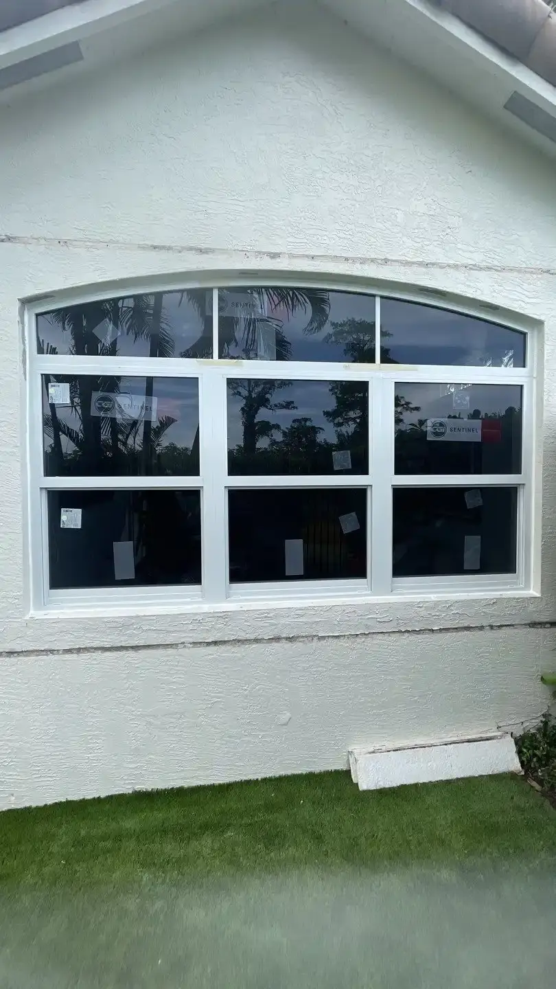 New impact window with white frame installed on a South Florida home