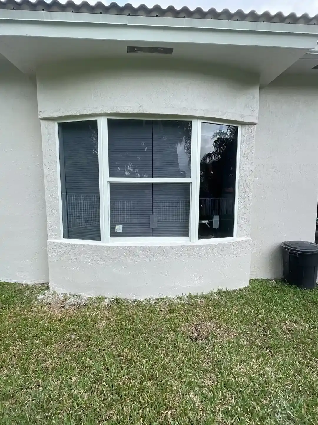 Sliding impact window installed in a stucco opening