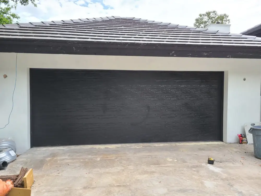 New two-car garage door fitted to a stucco elevation
