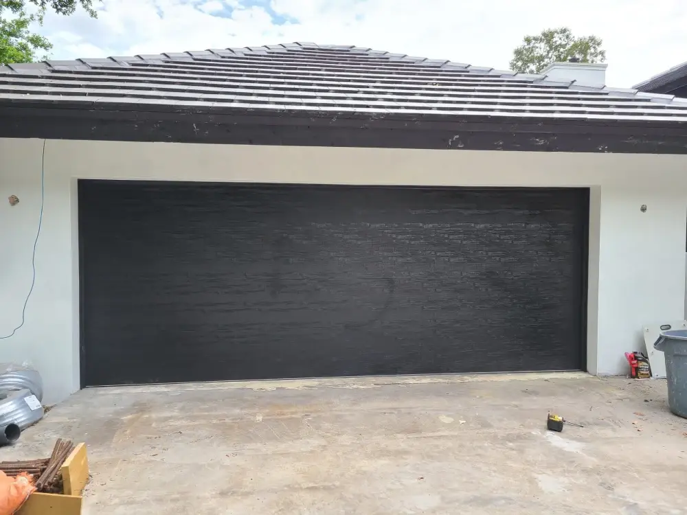 Newly installed sectional garage door on a South Florida residence