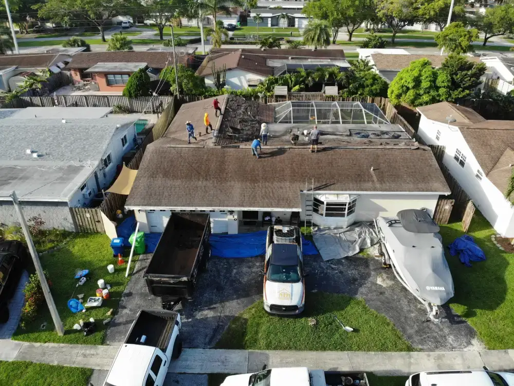 Aerial view of a Miami-Dade County, Florida neighborhood with tile roofs and roof work in progress
