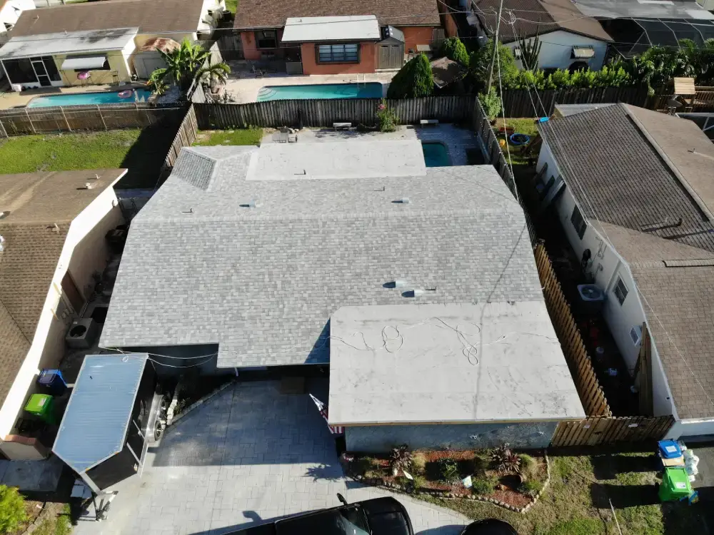 Aerial view of a Miami Gardens, Florida neighborhood with a roof replacement underway