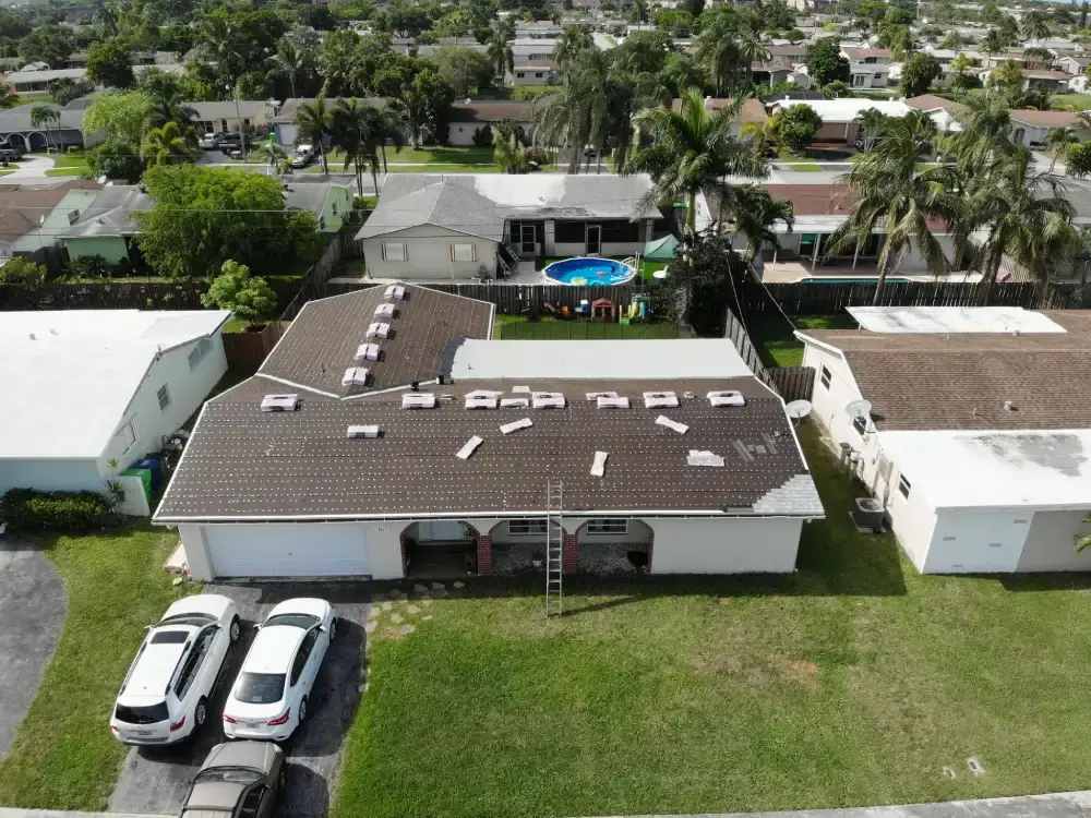 Aerial view of a Miramar, Florida neighborhood with roof replacement work underway