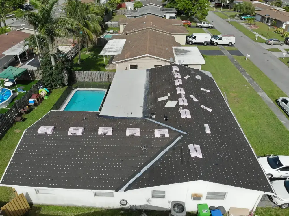 Aerial view of a Pompano Beach, Florida neighborhood with a roof replacement in progress