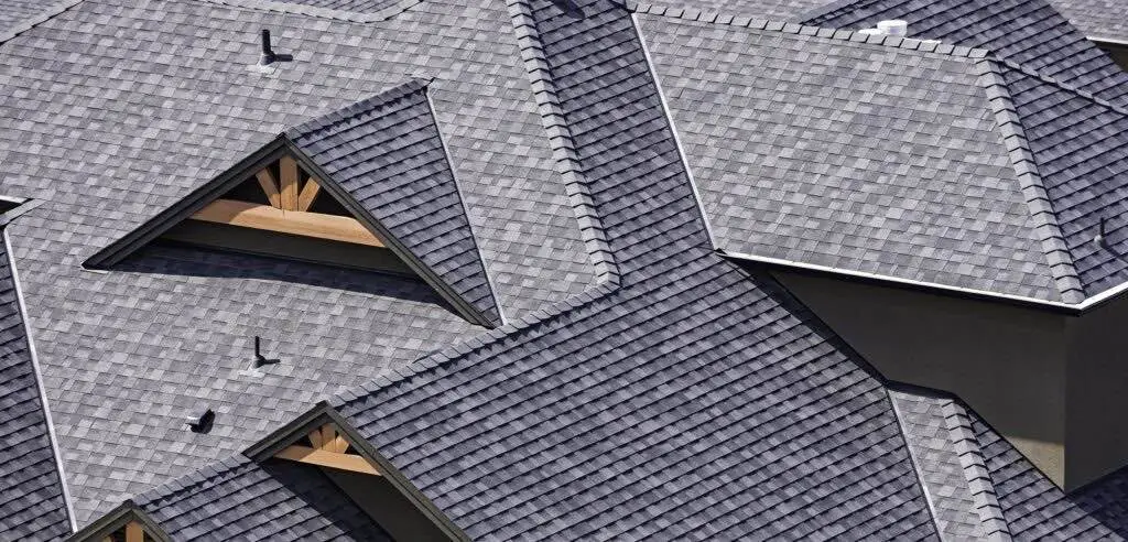 Cutaway view of an architectural shingle roof showing the shingle courses, underlayment and wood deck at a valley
