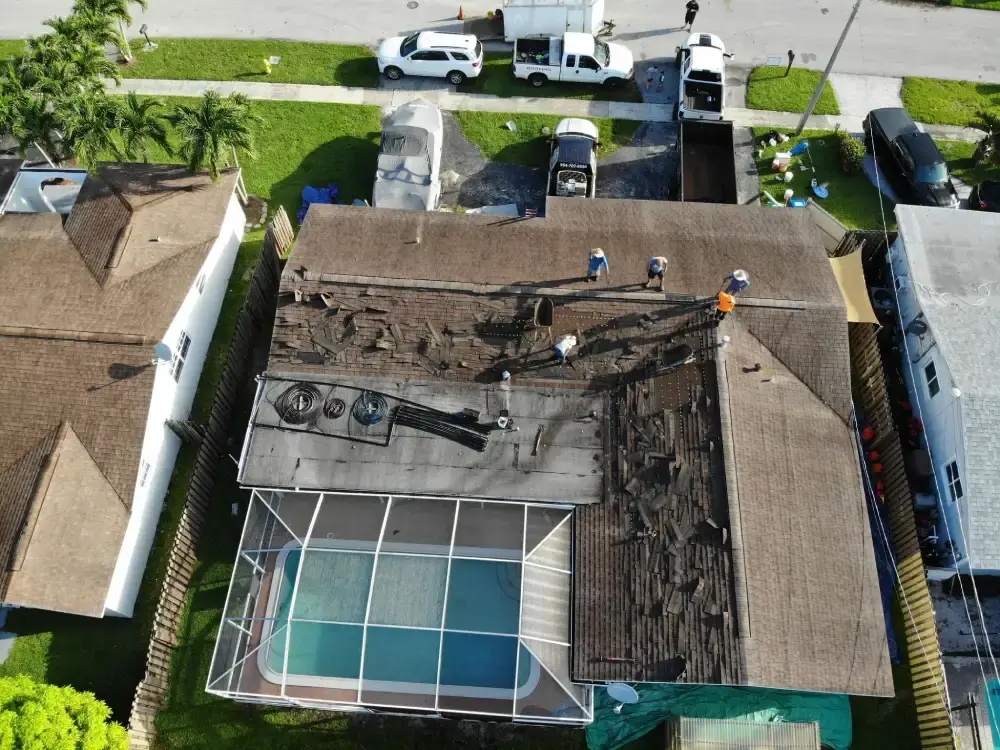 Aerial view of a South Florida home during a roof tear-off with the eave and fascia line exposed
